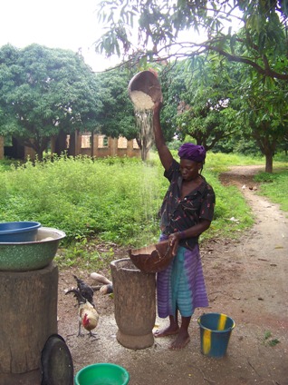 My host mother in Kayero, preparing some millet or corn, I don't remember which, to be eaten that same night.